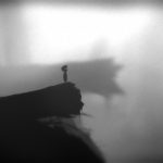 Limbo protagonist stands on the edge of a fallen tree, overlooking a fog-covered valley