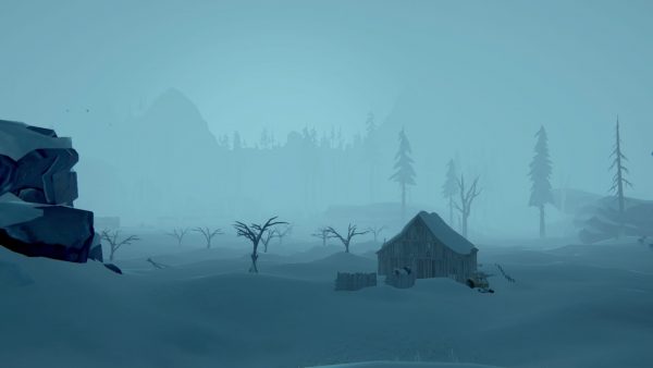 Deep snow surrounding a rickety wooden shack, surrounded by fog.